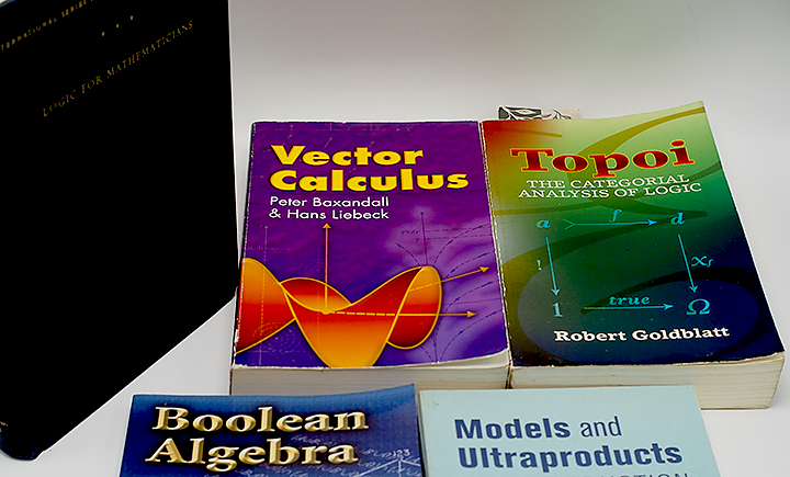 Showing some books from our personal library whilst briefly noting about fears about AI making its way to mathematics.