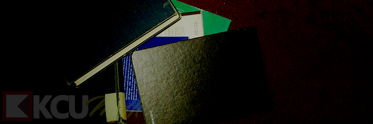 Stack of books reenacted as thrown on the carpet floor as a means of gesturing that today's students don't care about studying and learning, and in this case, not caring about math. What person would throw math books on the floor like this?